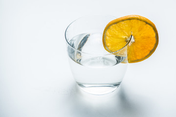Glass of pure water with citrus fruit