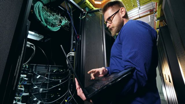 A programmer, IT specialist works with server computers.