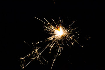 festive fire sparkler on black background