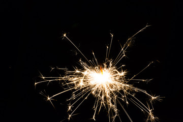 Diwali and new year festive fire sparkler on black background