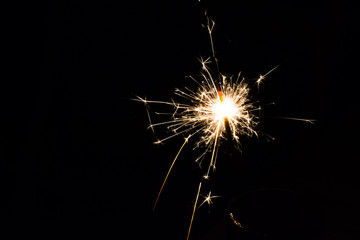 festive fire sparkler lit in the night