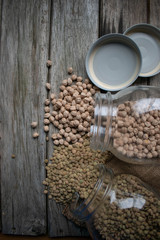Legumes jar, chickpeas and lentils on wooden background.
