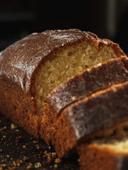 Rectangular loaf cut into pieces with a white sprinkle is on a rusty protvin.