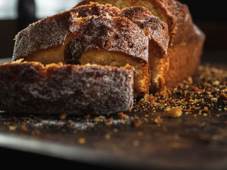 Rectangular loaf cut into pieces with a white sprinkle is on a rusty protvin.