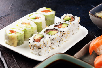 close up of sashimi sushi set with chopsticks and soy - sushi roll with salmon and sushi roll with smoked eel
