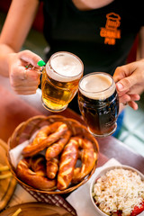 Friends toasting with beer in pub