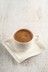 A cup of Turkish coffee on a wooden table