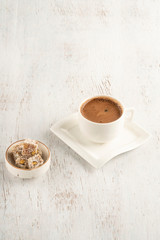 A cup of Turkish coffee and delight on a wooden table