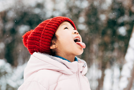 Cute girl playing in snow