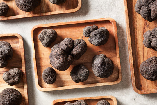 Composition of black truffles on wood trays