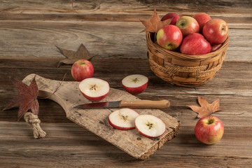 sliced apples on a wooden cutting board on a table