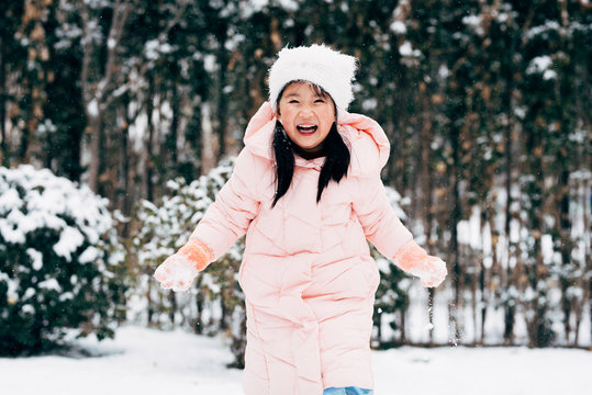 Cute girl playing in snow