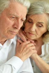 Close up portrait of sad senior couple