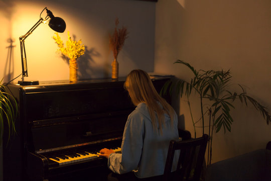 girl playing piano at home