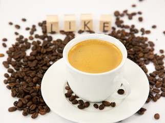 Coffee cup and beans close-up isolated on a white background.