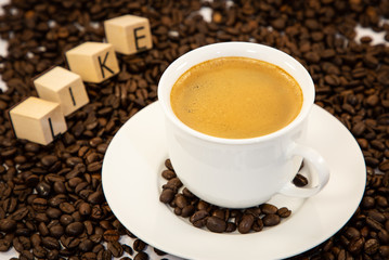 Coffee cup and beans close-up isolated on a white background.