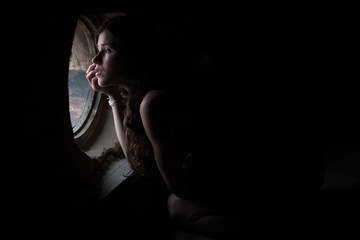 girl sitting in the attic window