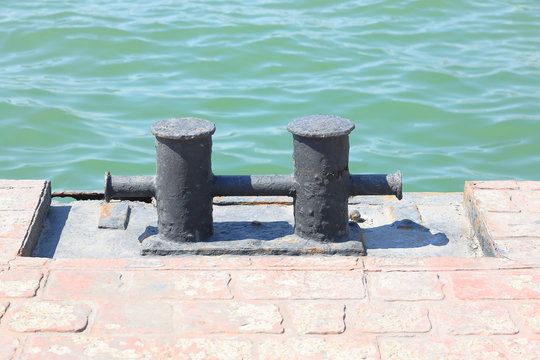 Mooring bollard for tying ships with a rope on the seashore