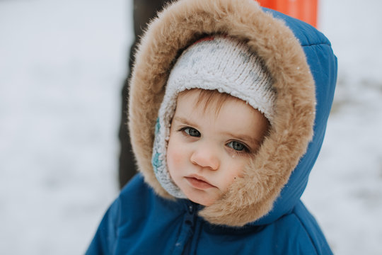 Cute Baby in Snow with Tear on Cheek
