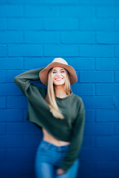 portrait of a happy woman on a blue urban background