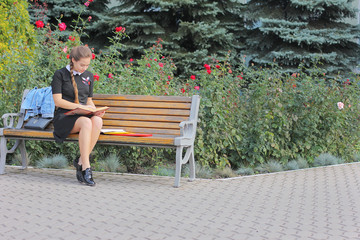 Beautiful girl reading a book near the institute