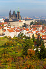 Obraz premium Autumn Prague City with gothic Castle and colorful Nature and Trees from the Hill Petrin, Czech Republic