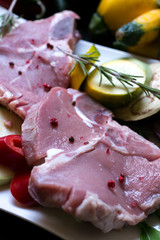 Fresh raw meat steak with vegetables close up