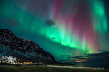 Colorful northern lights in Iceland on the beach 