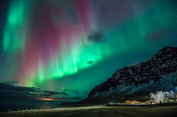 Colorful northern lights in Iceland on the beach 