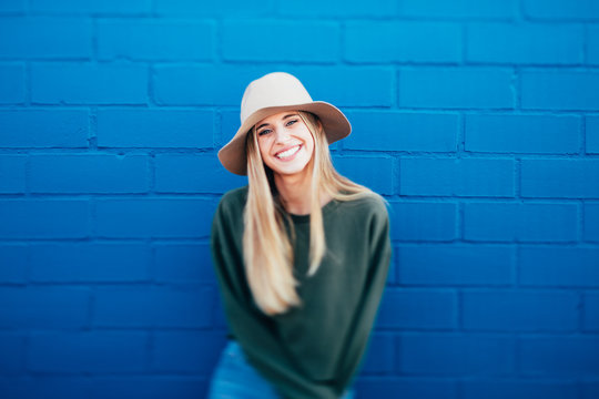 portrait of a happy woman on a blue urban background