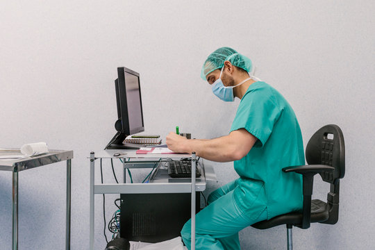 Surgeon using a laptop in the operating room