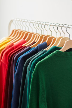 Vivid clothes hanging on rack