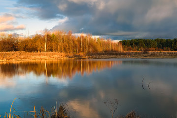 Autumn landscape by the river at sunset. Wonderful nature, beautiful natural background.