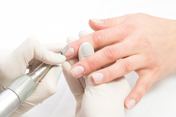 Female hand manicure procedure shot in closeup in a beauty salon.