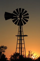 windmill at sunset with a colorful sky in Kansas north of Hutchinson.