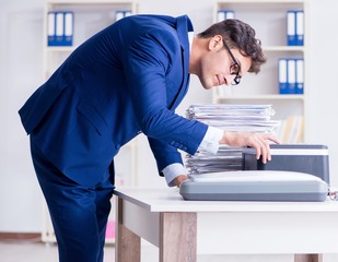 The businessman making copies in copying machine