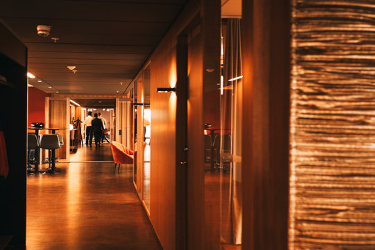 Mid Distant View Of Lawyers Walking In Corridor Of Law Office