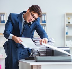 The businessman making copies in copying machine