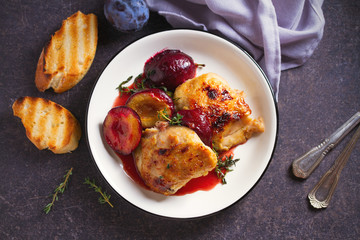 Baked chicken and plums in ginger, honey and red wine sauce with thyme. View from above, top view