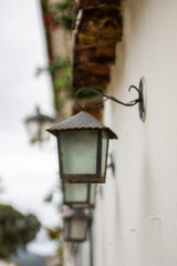 A sequence of wall lights in a white wall at the city of Paraty, Rio de Janeiro, world heritage in Brazil
