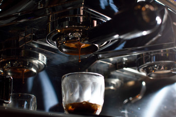 Fototapeta na wymiar Close-up of making coffee, a coffee machine pours espresso into a glass