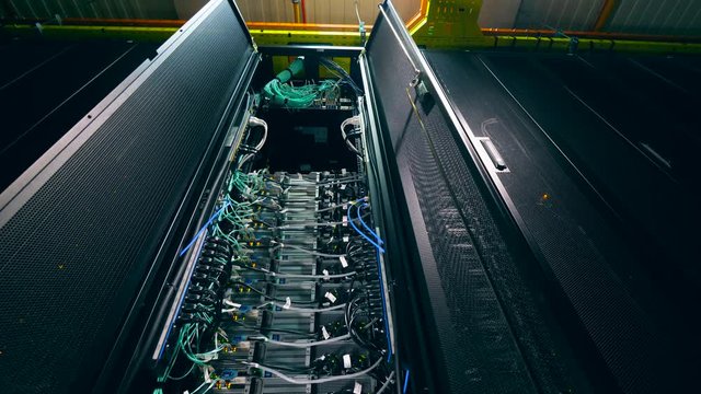 One computer with many cables in a server room.