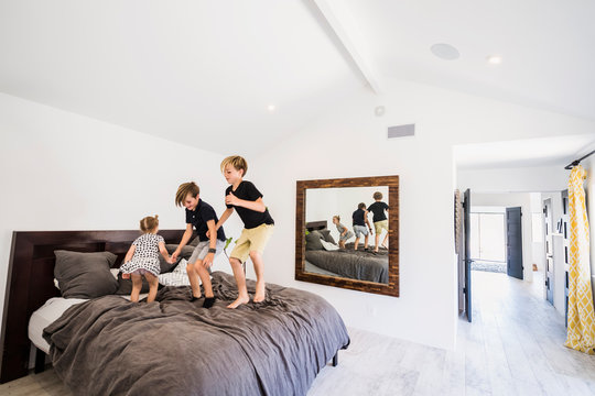 Children Jumping On Bed