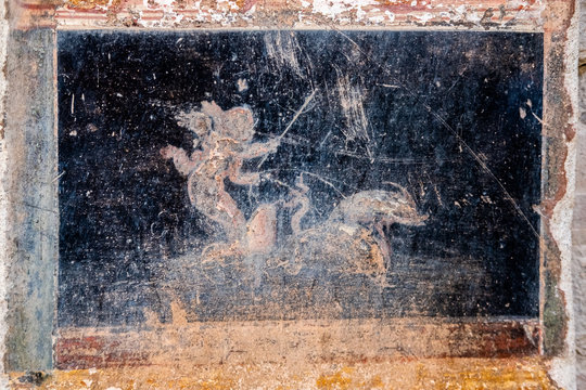 Winged Amorino Leads A Fish-drawn Chariot, A Figure Of Divinity Of Ancient Rome In Pompeii.