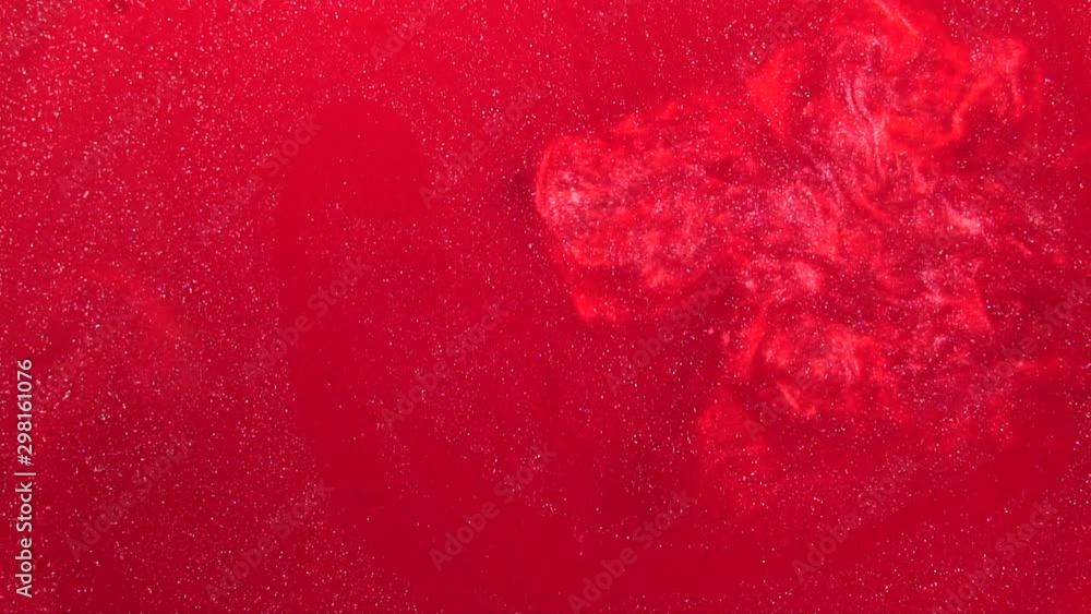 Poster red liquid with sparkles and pearly shine. abstract background. slow motion