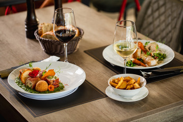Wine and served meal on dining at table.