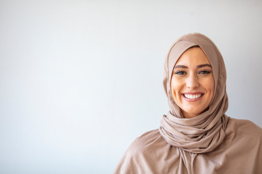 Modern, Stylish and Happy Muslim Woman Wearing a Headscarf. Arab saudi emirates woman covered with beige scarf. "Welcome" Face. One women smile with white background