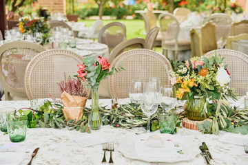 Floral decorative details of the centerpiece of a wedding restaurant in retro day style.