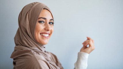 Portrait of pretty young asian muslim woman in head scarf smile. Pearl From The East. Smiling...