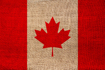 photo of the beautiful colored national flag of the modern state of Canada on textured fabric, concept of tourism, emigration, economics and politics, closeup